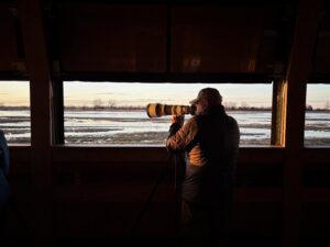 Wildlife photographers capturing Sandhill Cranes from inside private blinds along the Platte River in Nebraska